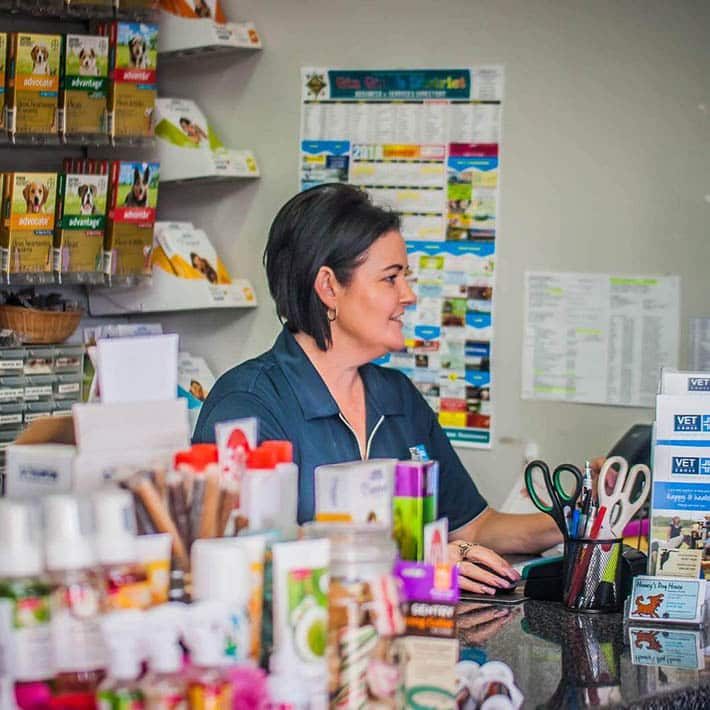 Woman assisting a customer in a pet store — Best Veterinary Services in Bundaberg, QLD